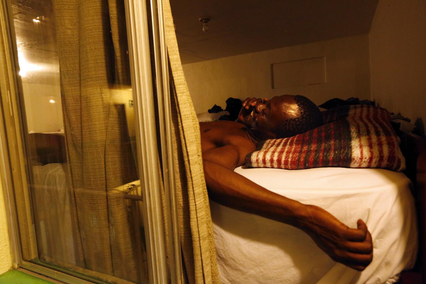 A Haitian migrant makes a call before going to sleep at the Casa del Migrante shelter in Tijuana, Mexica.