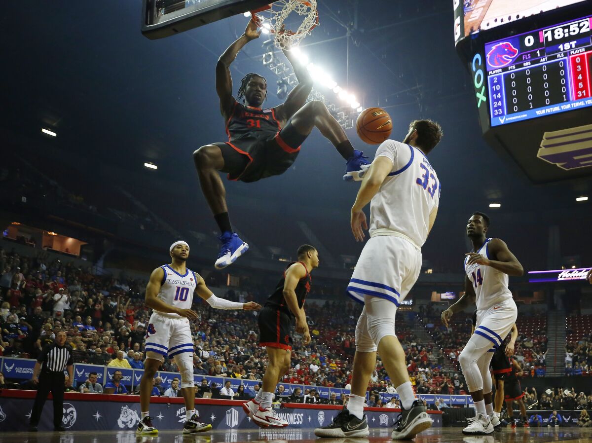 SDSU's Nathan Mensah dunks against Boise State in the final of the Mountain West tournament last March in Las Vegas.