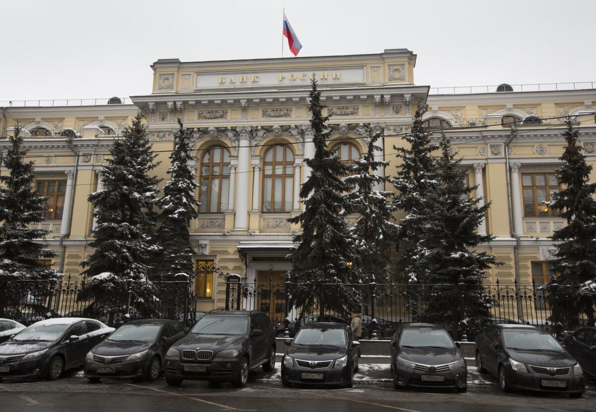 FILE - Cars are parked in front of Russia's Central Bank building in Moscow, Russia, Jan. 30, 2015.
