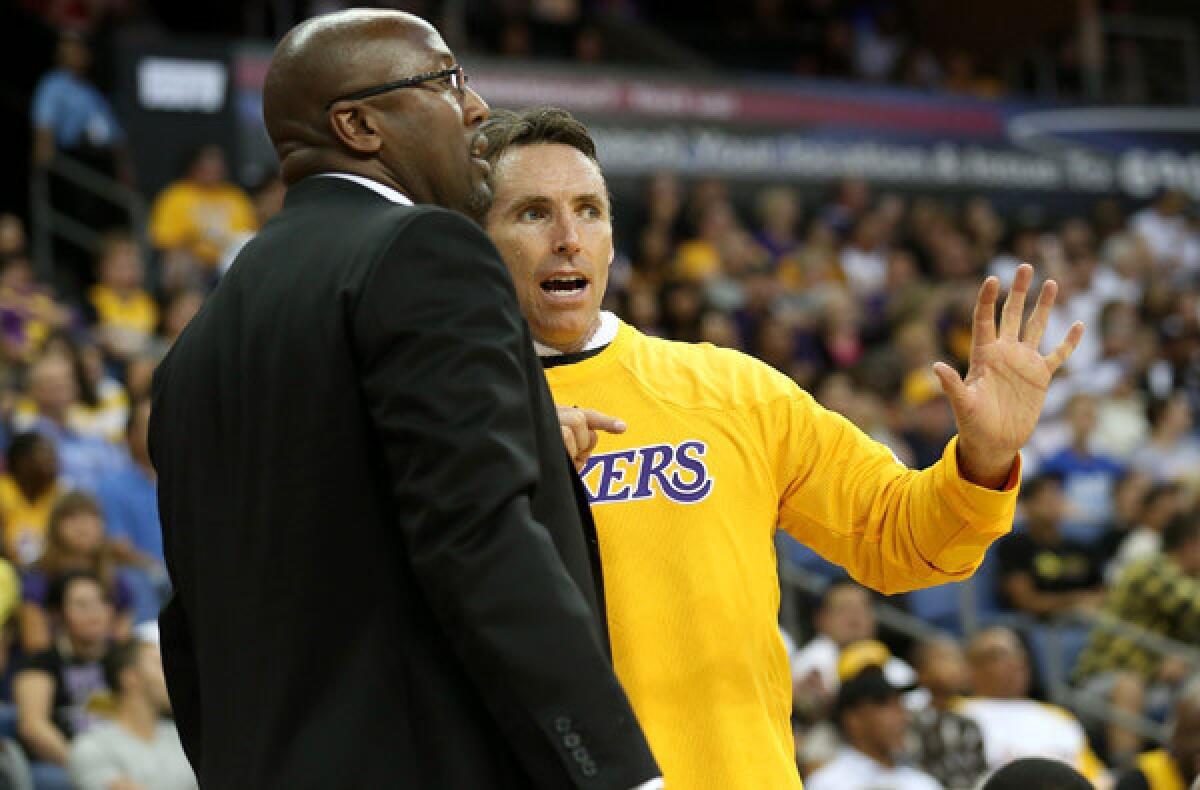 Lakers Coach Mike Brown and point guard Steve Nash discuss strategy during a break in an exhibition game.