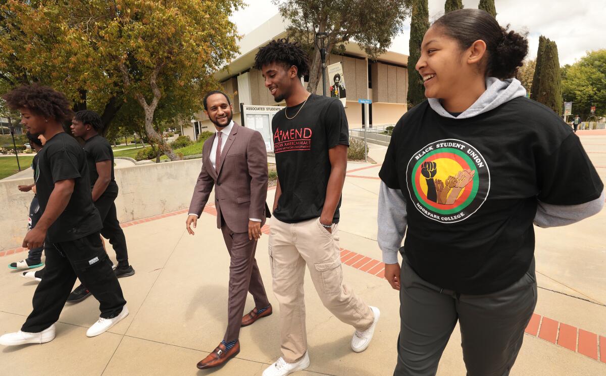 Dr. Amanuel Gebru talks with students on the Moorpark College campus. 