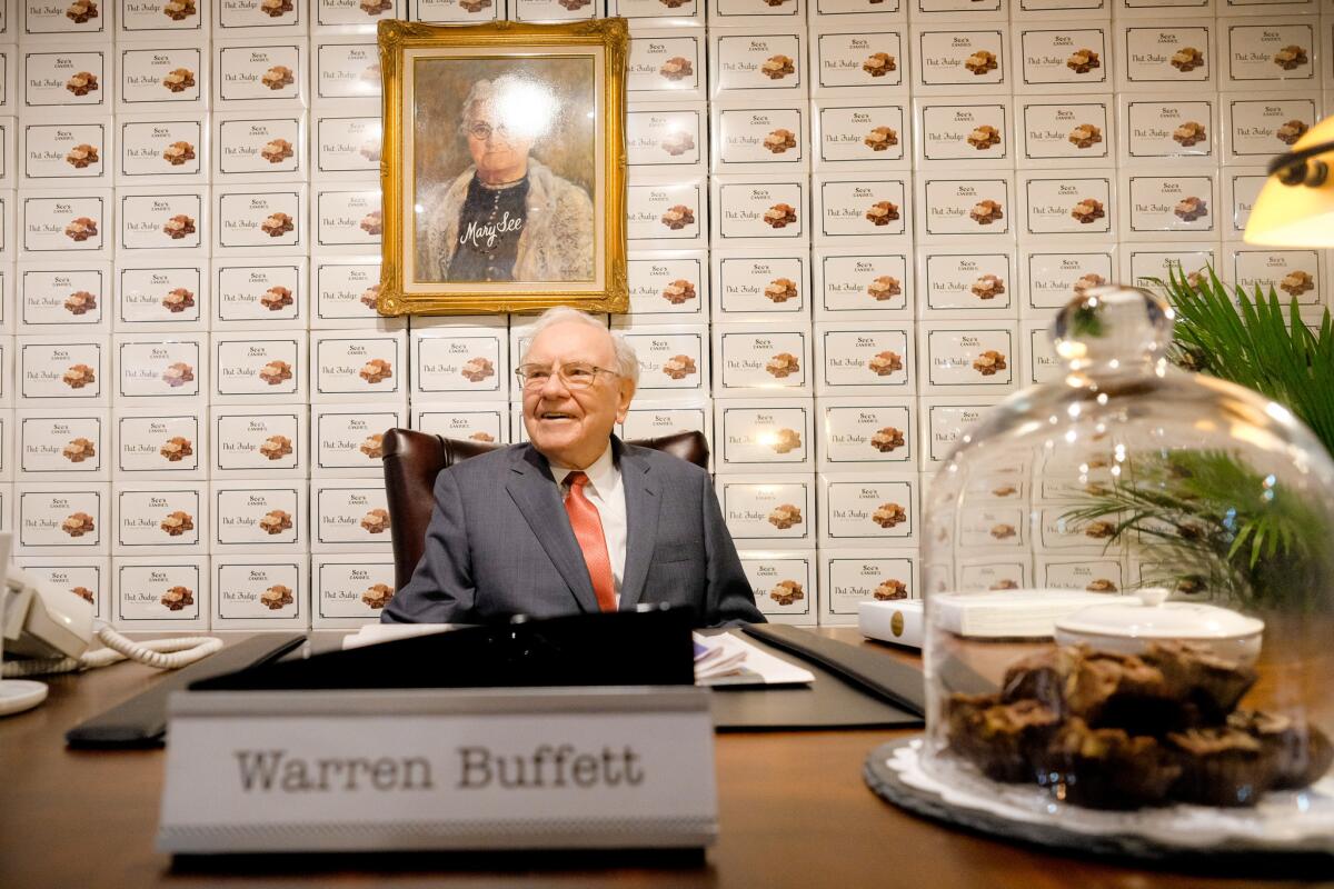 Warren Buffett sits at the See's Candies booth during the Berkshire Hathaway annual shareholders' meeting on April 29 in Omaha.