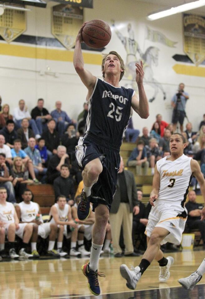 Newport Harbor High's Ben Bockrath (25) scores a layup during the first half against Foothill in a CIF Southern Section Division 2AA first-round playoff game on Friday.