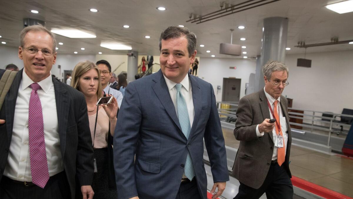 Republican Senator Ted Cruz (C) speaks to members of the news media near the Senate subway on Capitol Hill in Washington on May 10.