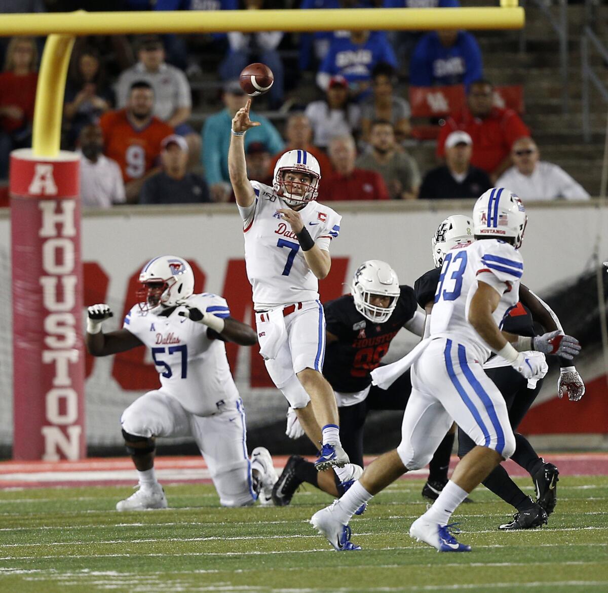 SMU's Shane Buechele (7) throws a pass across the middle to Kylen Granson (83) during the first half against Houston on Thursday in Houston.