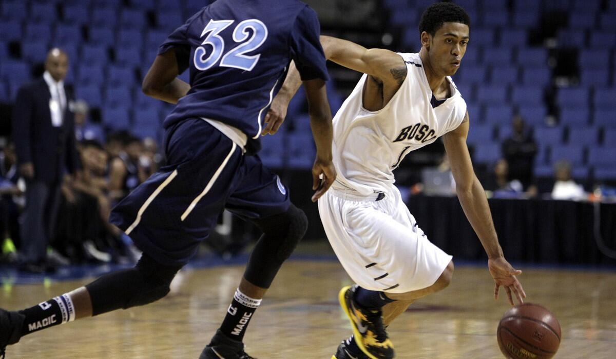 St. John Bosco's Tyler Dorsey drives against Compton's Raysean Scott during a playoff game this spring.