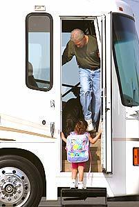 Seal Beach resident Brian Brown and his 4-year-old daughter, Sarah, meet on the steps of the RV the family has just purchased for camping trips, despite a rocky first experience in a rented vehicle.