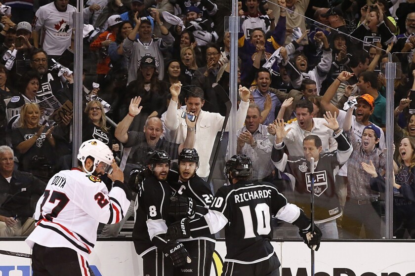 Kings fans cheer as Drew Doughty (8), Dustin Brown (23) and Mike Richards (10) celebrate a go-ahead goal by Doughty in the third period of Game 6 against the Chicago Blackhawks.