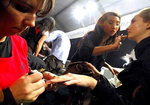 A model gets her nails done behind the scenes at the Costello Tagliapietra fashion show.