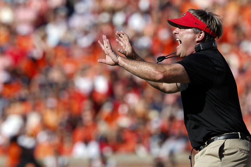 Georgia head coach Kirby Smart signals to players during the first half of an NCAA football game against Auburn, Saturday, Sept. 30, 2023, in Auburn, Ala. (AP Photo/ Butch Dill )