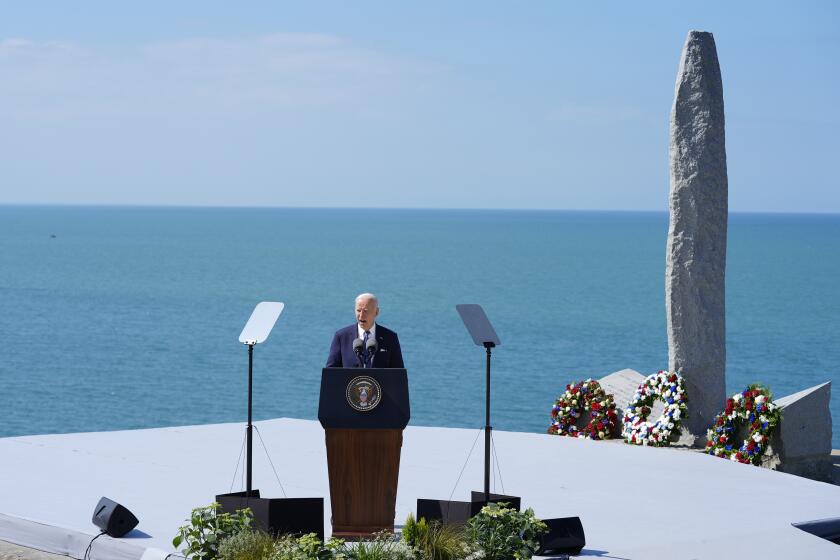 President Joe Biden delivers a speech on the legacy of Pointe du Hoc, and democracy around the world, Friday, June 7, 2024 as he stands next to the Pointe du Hoc monument in Normandy, France. (AP Photo/Evan Vucci)