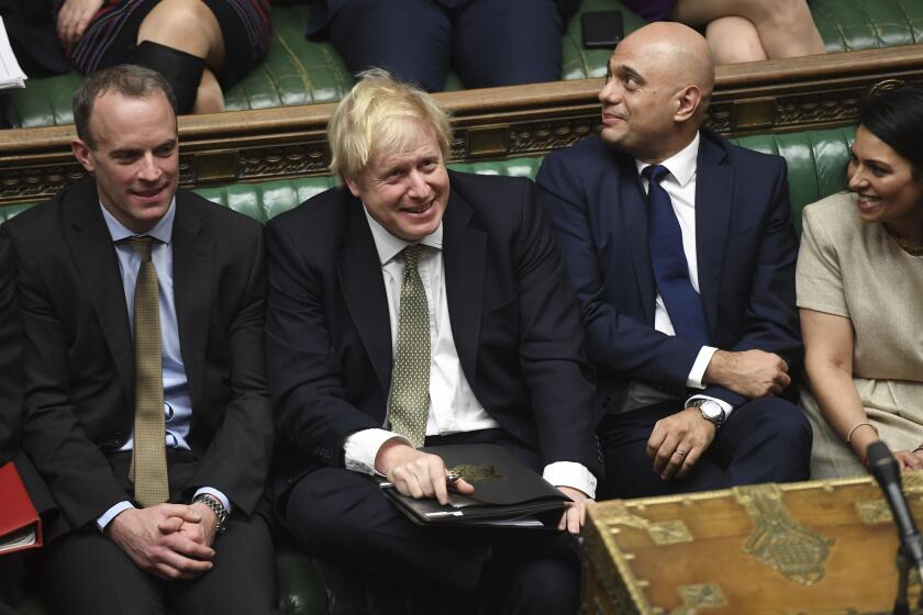 In this photo made available by the UK Parliament, Britain's Prime Minister Boris Johnson, center, attends the debate in the House of Commons, London, Thursday Dec. 19, 2019. Boris Johnson signaled an end to Britain’s era of Brexit deadlock Thursday, announcing a packed legislative program intended to take the U.K. out of the European Union on Jan. 31, overhaul everything from fishing to financial services and shore up the country’s cash-starved public services. (Jessica Taylor/UK Parliament via AP)