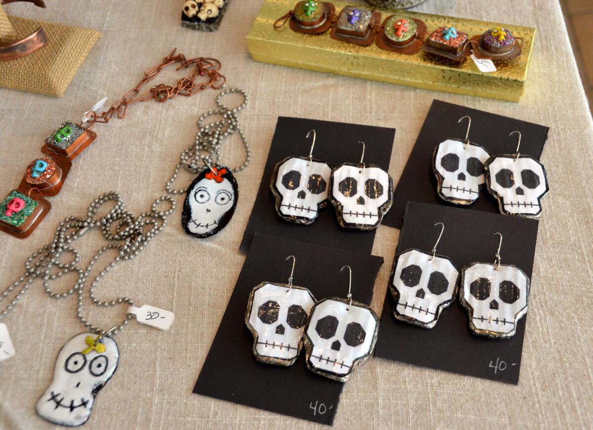 Jewelry artisan Linda Bucci (Ms. Gotrocks) displays her quirky novelty pieces at the Art in the Park event.