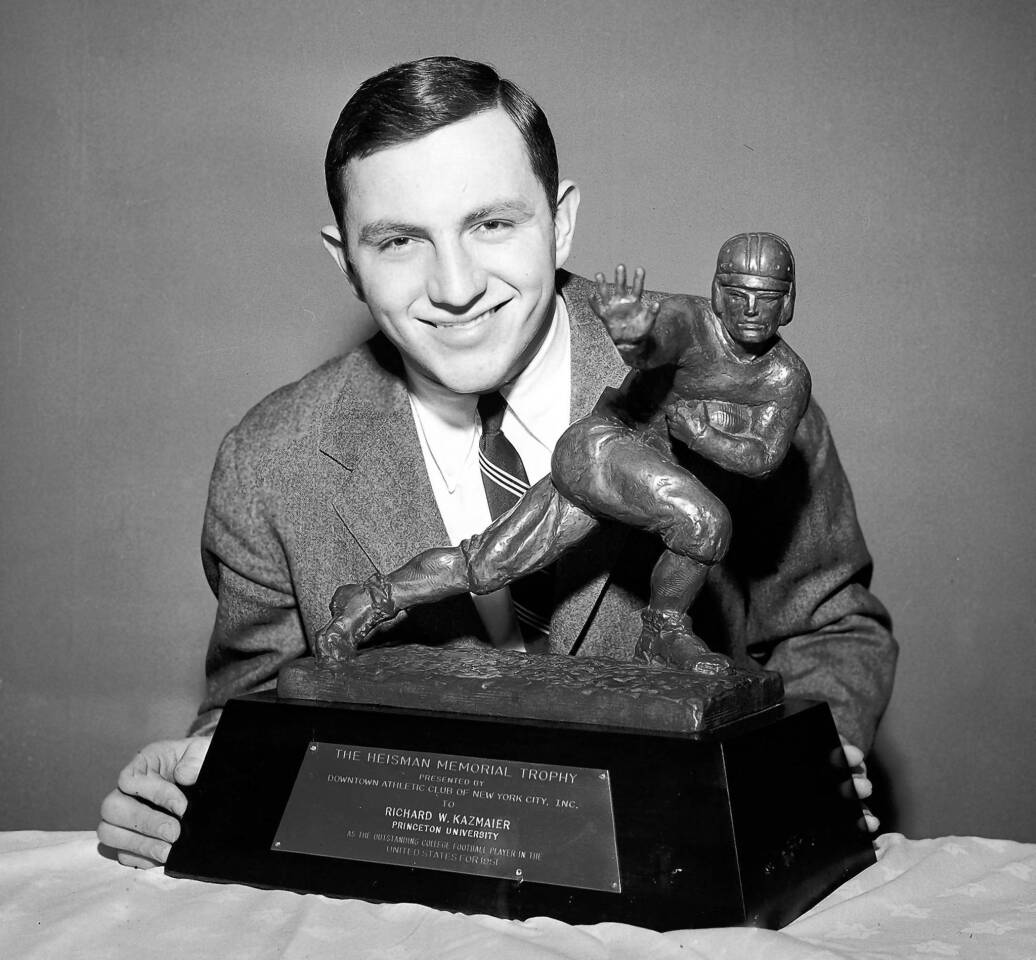 In this Dec. 11, 1951, photo, Dick Kazmaier of Princeton University shows off his Heisman Trophy. Kazmaier has died at 82.
