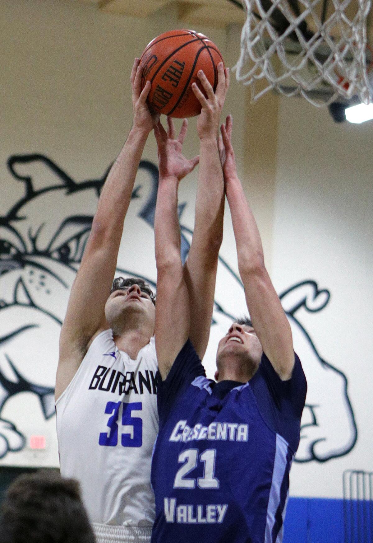 Burbank's Kevin Sarkes and Crescenta Valley's Ryan Raad battle for a rebound in a Pacific League boys' basketball game at Burbank High School on Thursday, December 19, 2019.