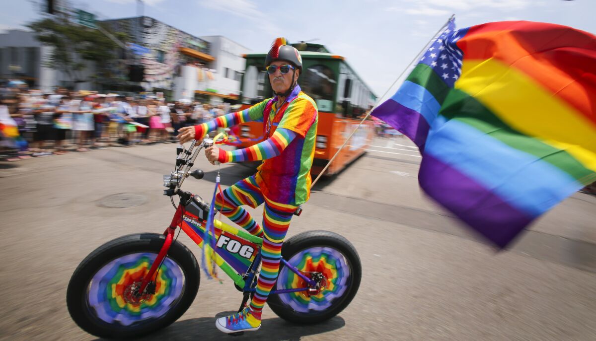 Jim Osborne rides his bike along the 2017 San Diego Pride parade route on University Avenue.