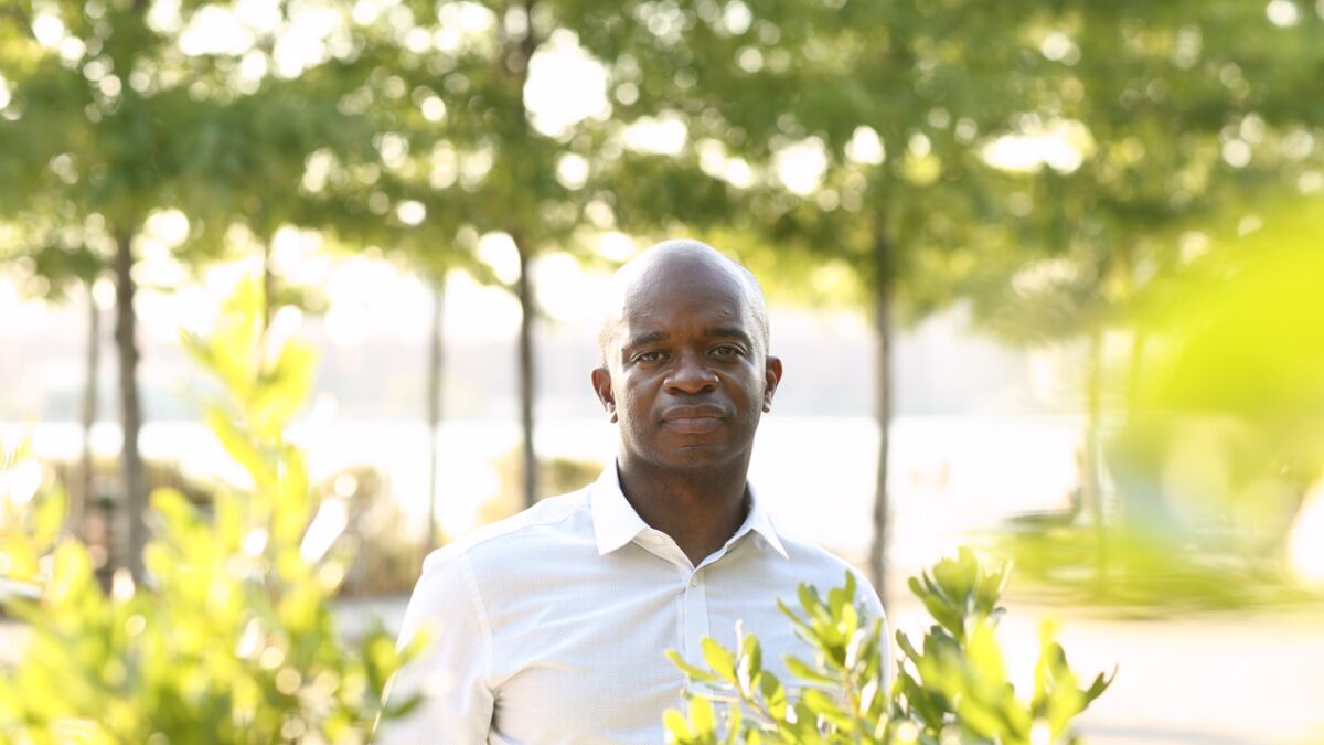 A portrait of Joseph Illidge outside with trees in the background.