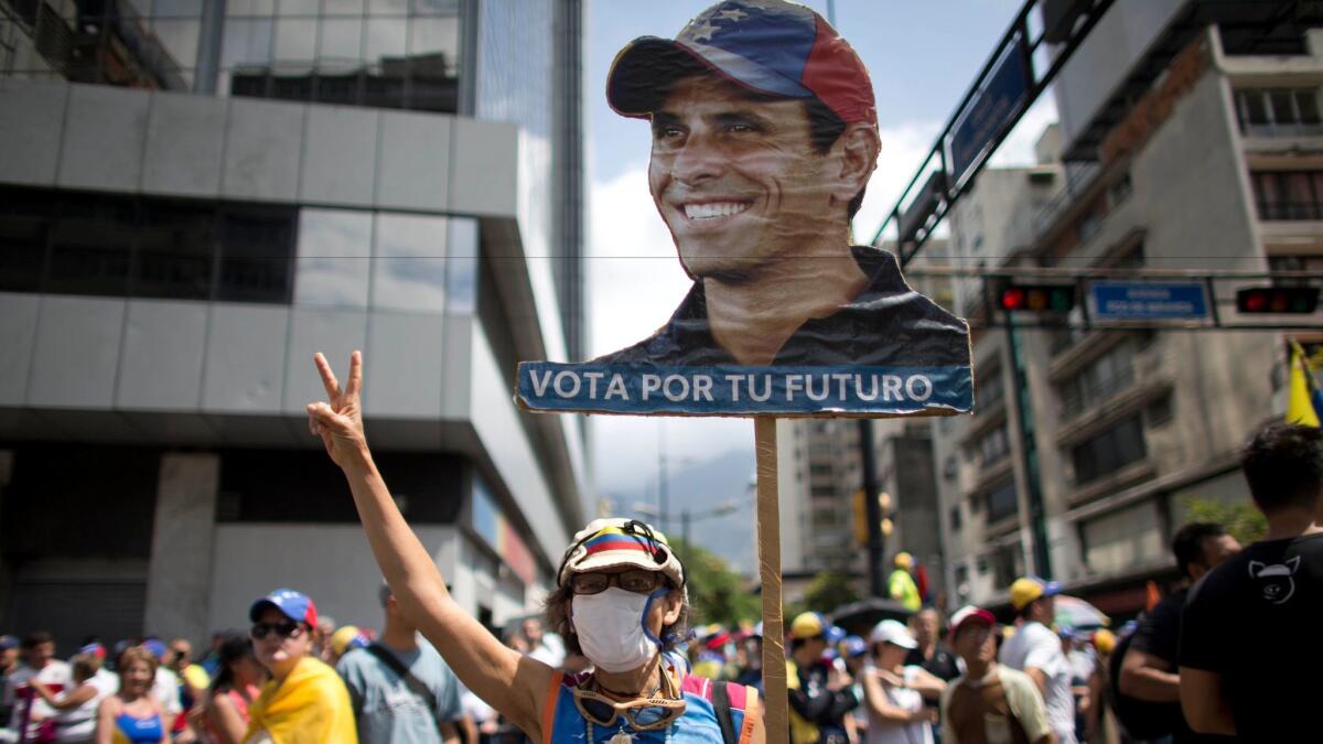 A woman shows her support for Venezuelan opposition leader Henrique Capriles as people gather for a demonstration against President Nicolas Maduro in Caracas, Venezuela, on April 8.