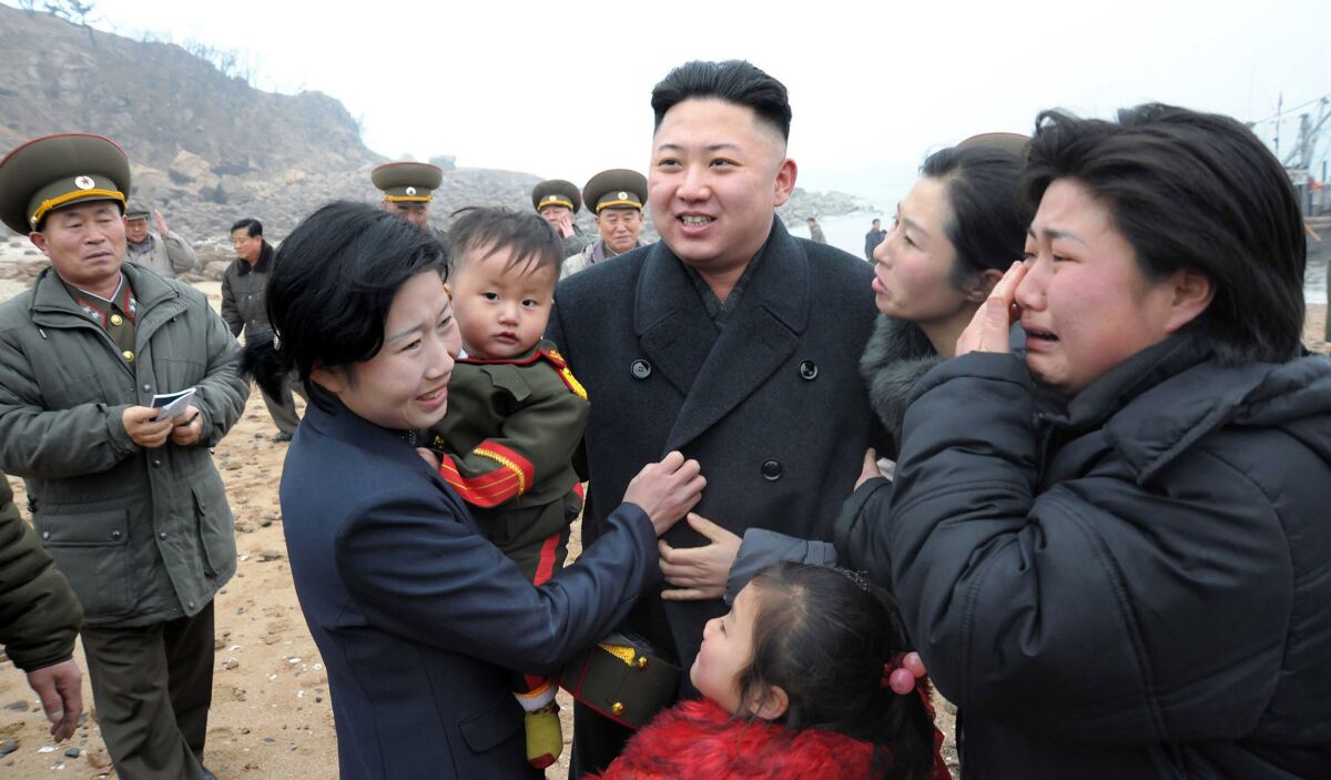 Kim Jong Un meets with the family of a soldier as he inspects the Jangjae Islet defense detachment on March 7, 2013.