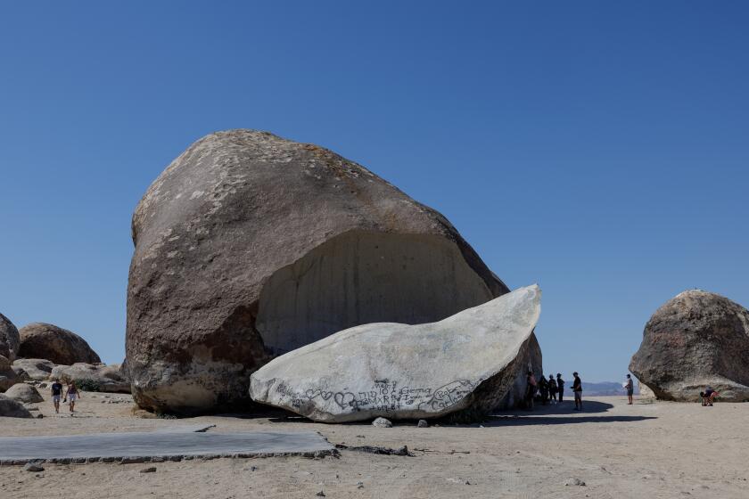 LANDERS, CA - MAY 30, 2024: A group from Contact in the Desert, a UFO convention, visits the Giant Rock, a seven story high boulder in the Mojave Desert on May 30 2024 in Landers, California. (Gina Ferazzi / Los Angeles Times)