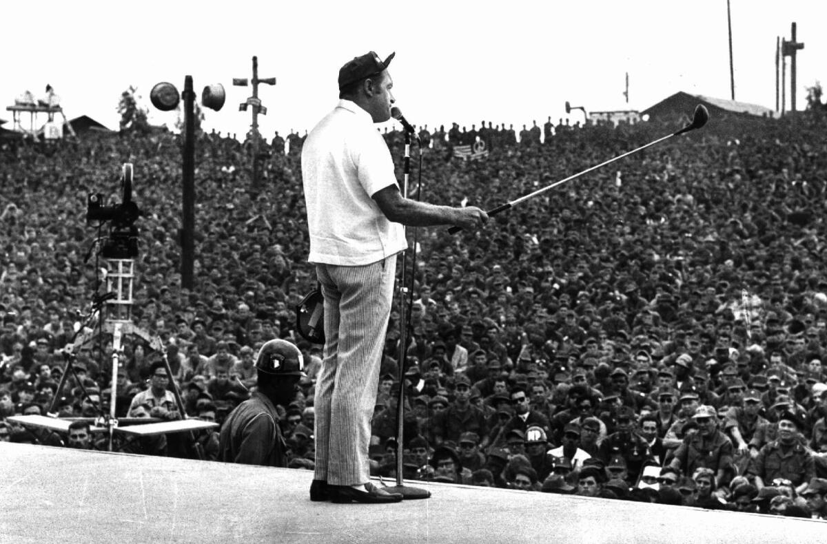 Bob Hope cracks jokes to an audience of thousands of GI's massed in an open-air theater in Cu Chi, 20 miles northeast of Saigon during a 1969 Christmas tour of Vietnam. (Associated Press)