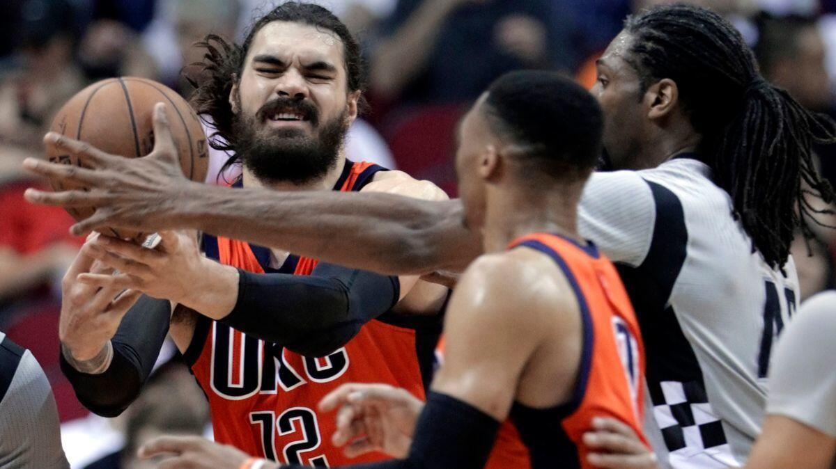 Oklahoma City Thunder's Steven Adams (12) battes for a rebound with Houston Rockets' Nene (42) as Russell Westbrook (0) looks on in the second halfon, March 26.