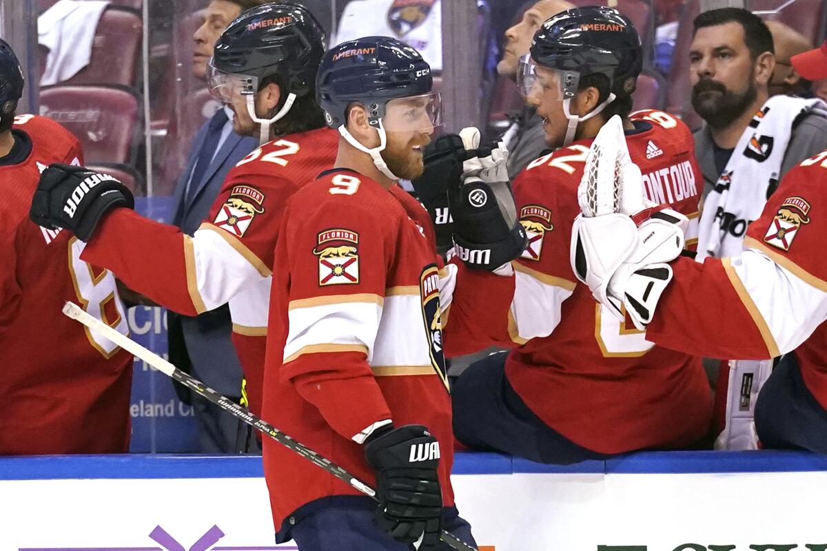 Florida Panthers center Sam Bennett (9) is congratulated after scoring a goal during the first period of an NHL hockey game against the New York Islanders, Saturday, Oct. 16, 2021, in Sunrise, Fla. (AP Photo/Lynne Sladky)