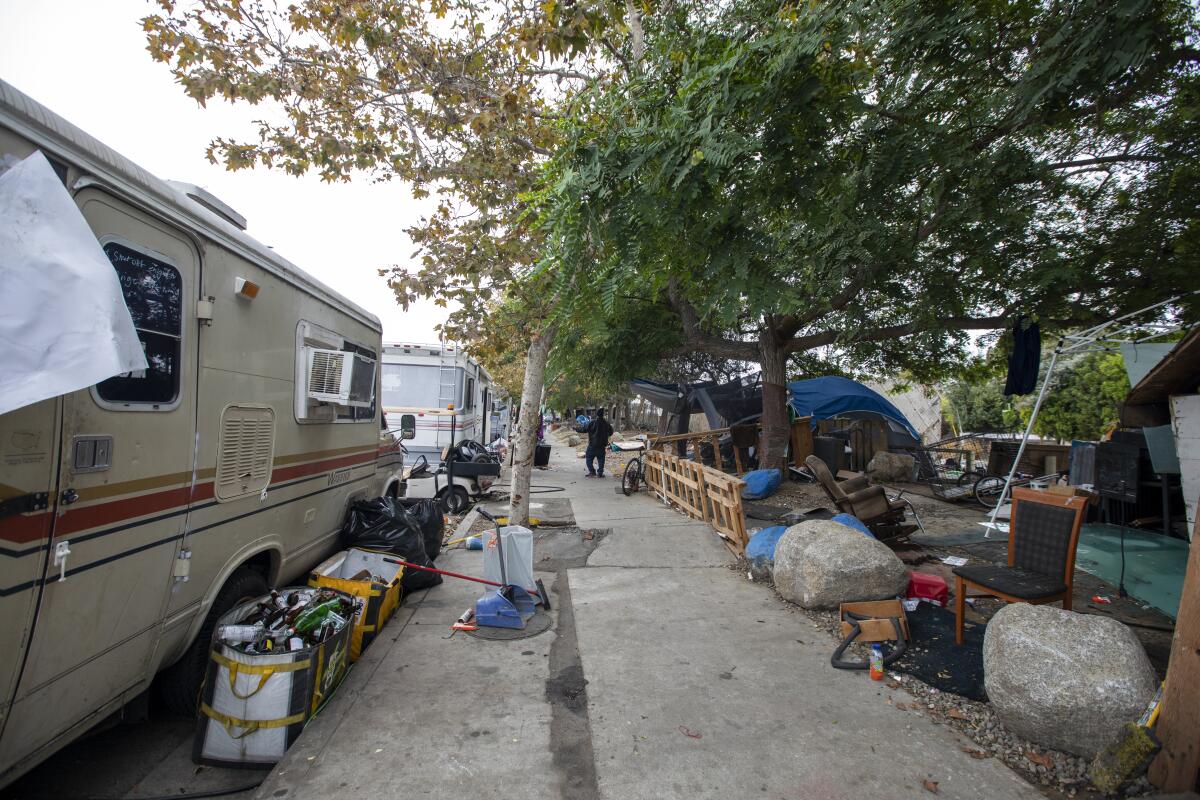 RVS, tents and detritus at a homeless encampment.