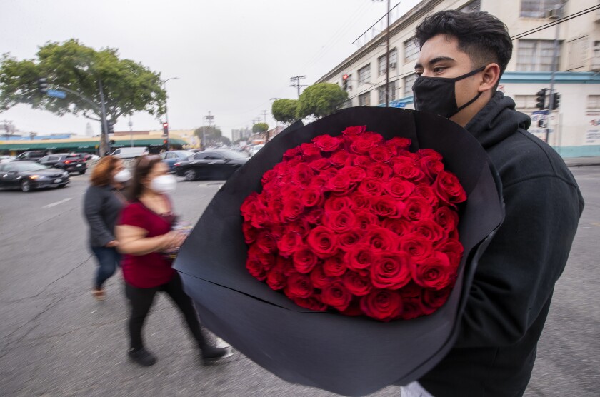 A flower shortage is driving up costs for a Mother's Day of
post-COVID-19 reunions 3 Man with roses