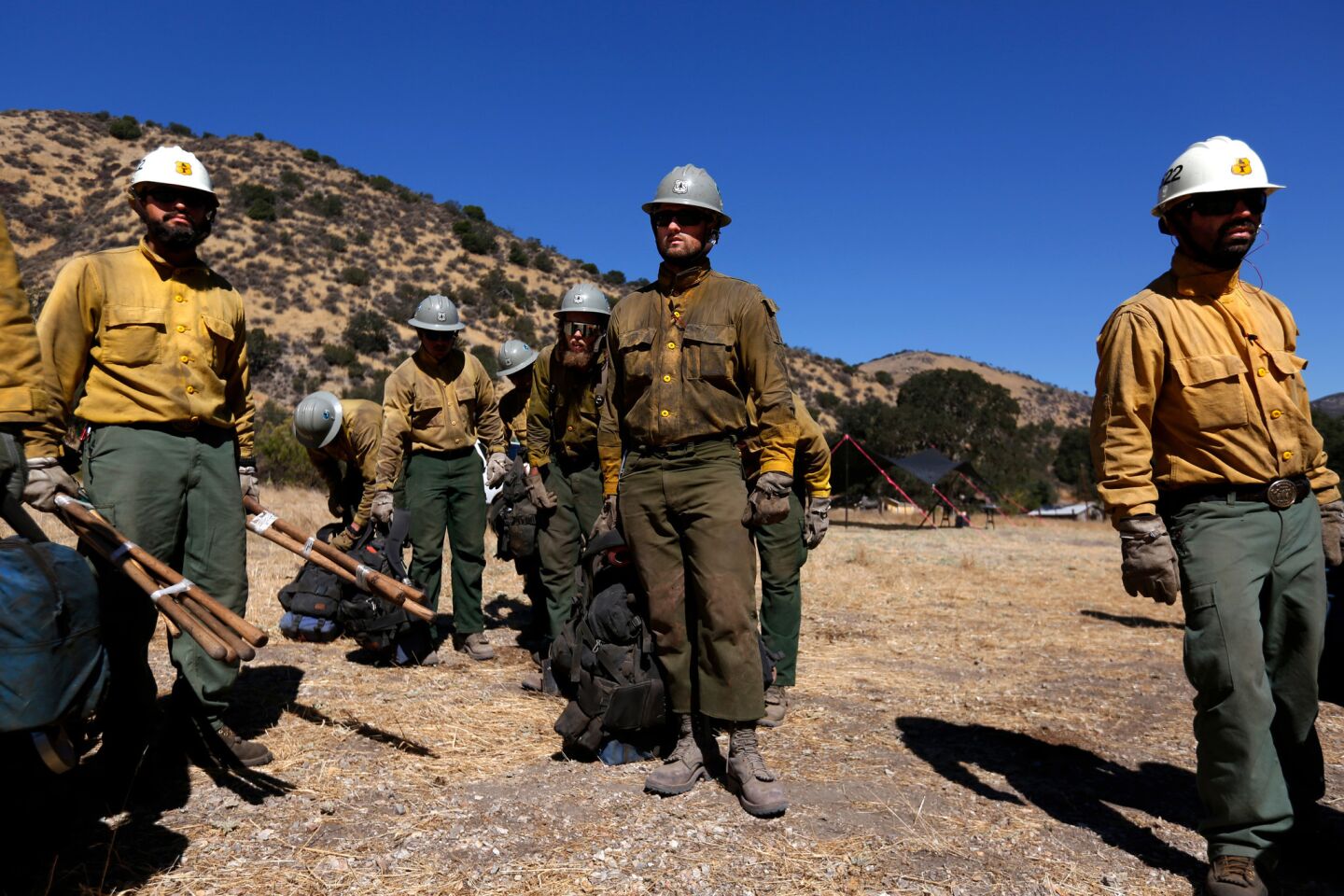 Members of the U.S. Forest Service Smith River Hotshot Crew wait to be air-lifted by helicopter to battle the Soberanes fire burning in Garrapata State Park in the Los Padres National Forest.