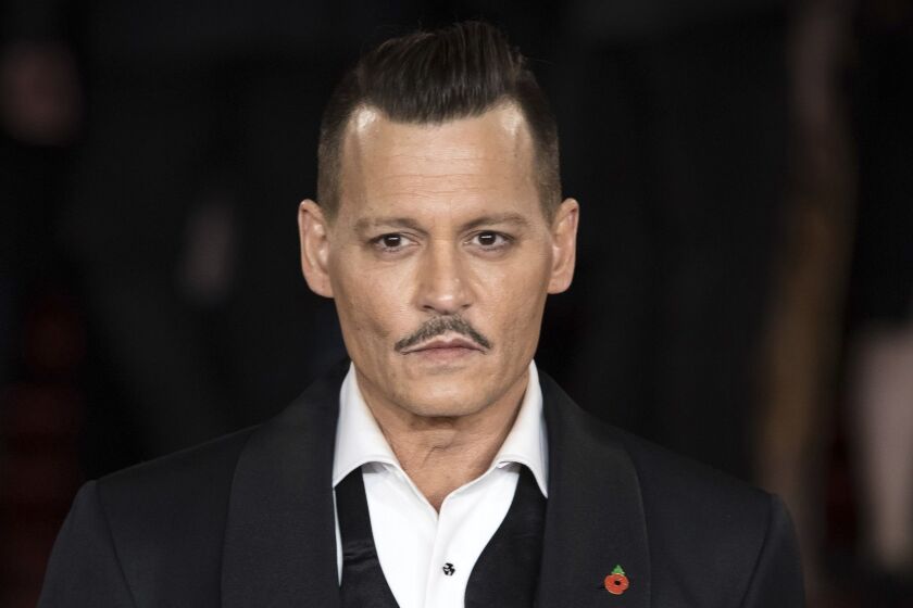 FILE - In this Nov. 2, 2017 file photo, actor Johnny Depp poses at the world premiere of the film "Murder on the Orient Express", in London. A film crew member is alleging in a lawsuit that Depp twice punched him on the Los Angeles set of a movie about the killing of the Notorious B.I.G. The suit filed Friday, July 6, 2018, in Los Angeles County Superior Court by location manager Gregg âRockyâ Brooks also claims that he was fired from the movie, âCity of Lies,â when he refused to sign papers saying he wouldnât sue over the incident. (Photo by Vianney Le Caer/Invision/AP, File)