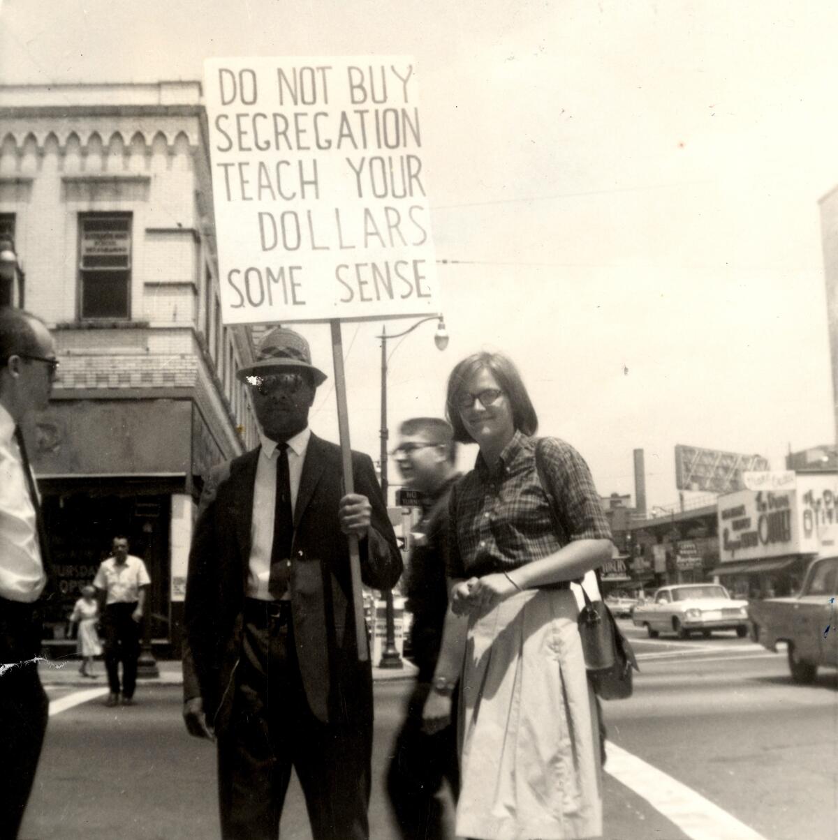 A white woman at a civil rights protest, right, with a Black man holding a picket sign in Alabama.