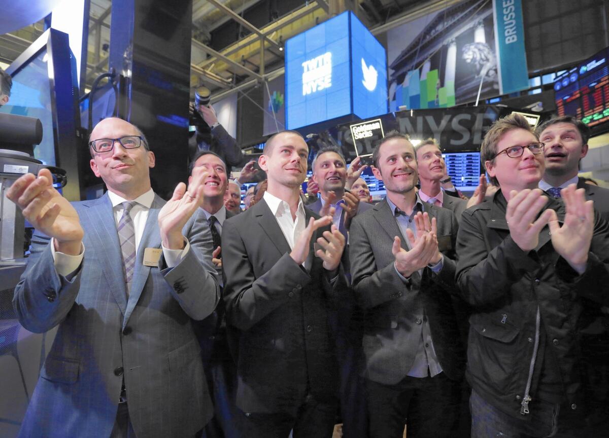 Twitter is not profitable, by any standard accounting measure. Its losses even increased leading up to its IPO. Above, front row from left, then-Twitter CEO Dick Costolo, Chairman and co-founder Jack Dorsey, and co-founders Evan Williams and Biz Stone applaud as they watch the ringing of the opening bell at the New York Stock Exchange in 2013.