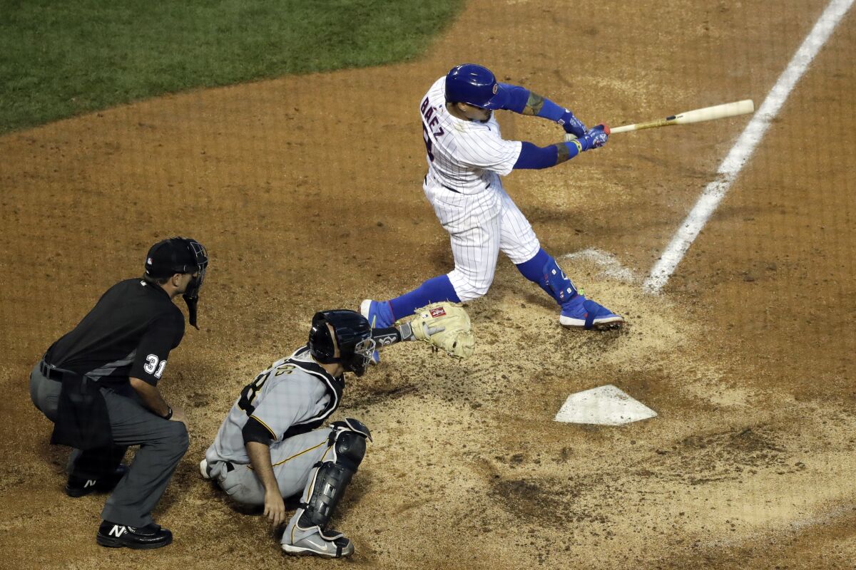 Chicago Cubs' Javier Baez, right, hits a winning single during the 11th inning of a baseball game against the Pittsburgh Pirates in Chicago, Sunday, Aug. 2, 2020. (AP Photo/Nam Y. Huh)