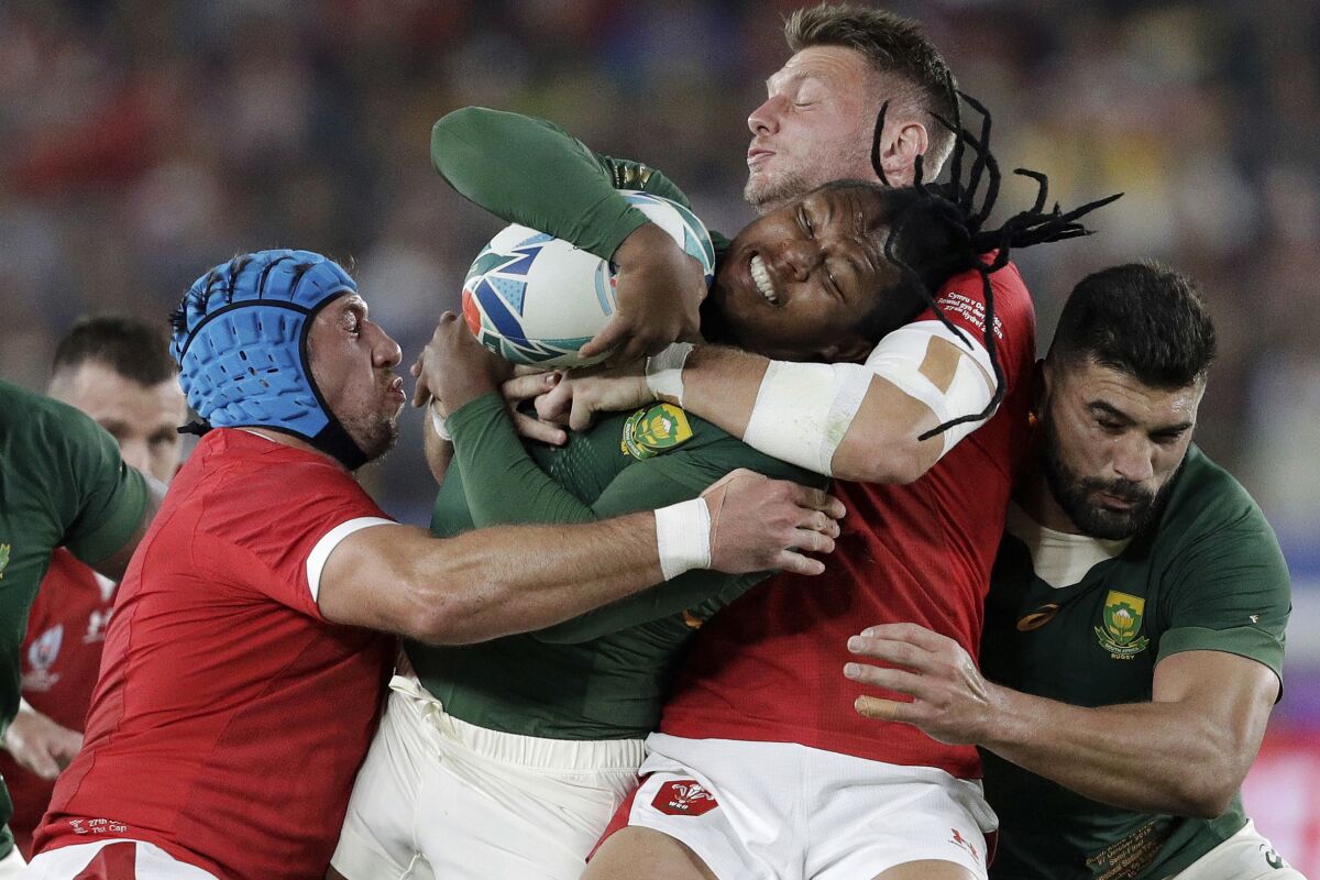 FILE - Wales' Dan Biggar, second right, tackles South Africa's S'Busiso Nkosi during the Rugby World Cup semifinal at International Yokohama Stadium between Wales and South Africa in Yokohama, Japan, Sunday, Oct. 27, 2019. The United States has landed another World Cup. The Rugby World Cup, in 2031. (AP Photo/Mark Baker, File)