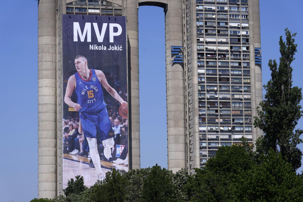 A billboard depicting Denver Nuggets center Nikola Jokic hangs on a building in Belgrade, Serbia, Friday, May 13, 2022. Jokic has earned a second straight NBA Most Valuable Player trophy to become the second consecutive international player to win two in a row. The 27-year-old from Serbia averaged 27.1 points, 13.8 rebounds and 7.9 assists. (AP Photo/Darko Vojinovic)