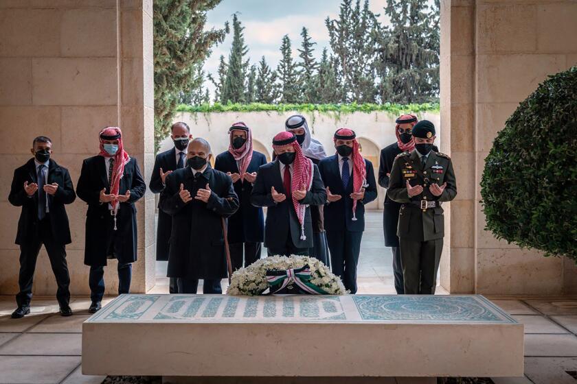 This photo from the Royal Court twitter account, shows Jordan’s King Abdullah II, center, Prince Hamzah bin Al Hussein, second left, and others during a visit to the tomb of the late King Hussein, in Amman Jordan, Sunday, April 11, 2021. Abdullah II and his half brother Prince Hamzah have made their first joint public appearance since a palace feud last week. Members of the Jordanian royal family Sunday marked the centenary of the establishment of the Emirate of Transjordan, a British protectorate that preceded the kingdom. (Royal Court Twitter Account via AP)