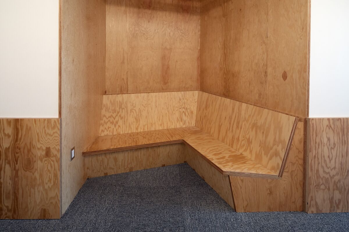 An alcove crafted from plywood with bench seating