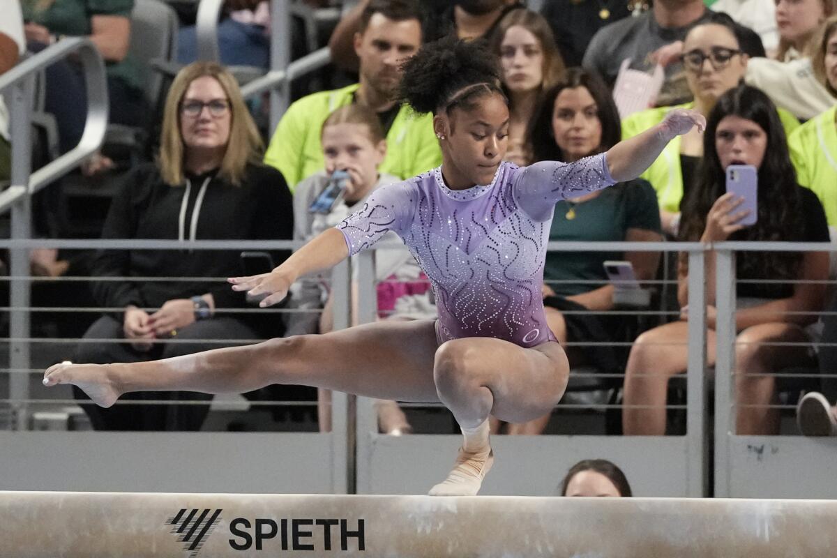 Skye Blakely balances on one leg during her beam routine at the U.S. gymnastics championships.