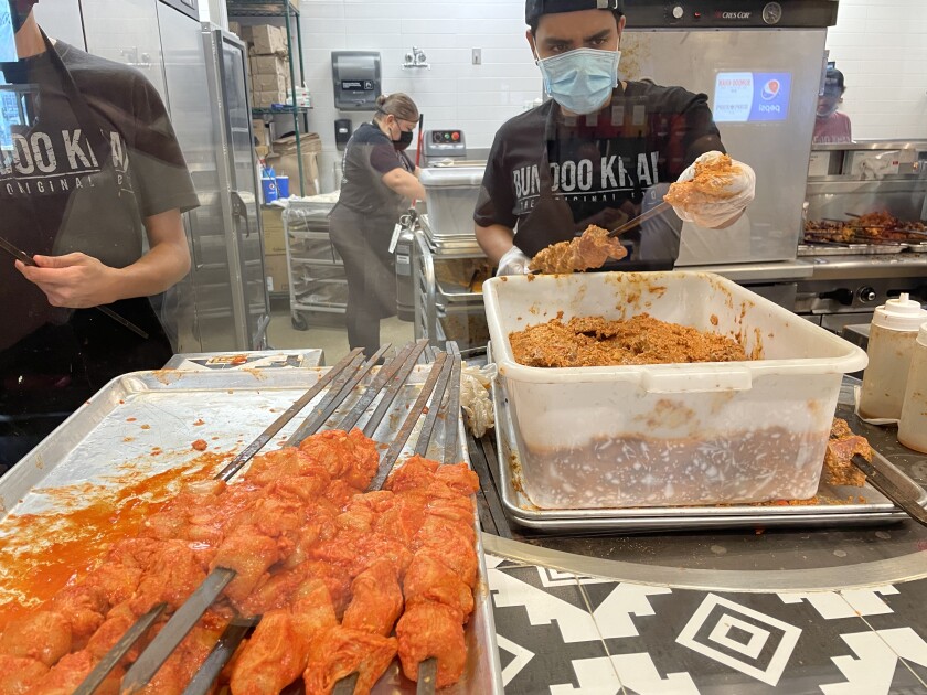Workers prepare food inside Bundoo Khan in Fullerton.
