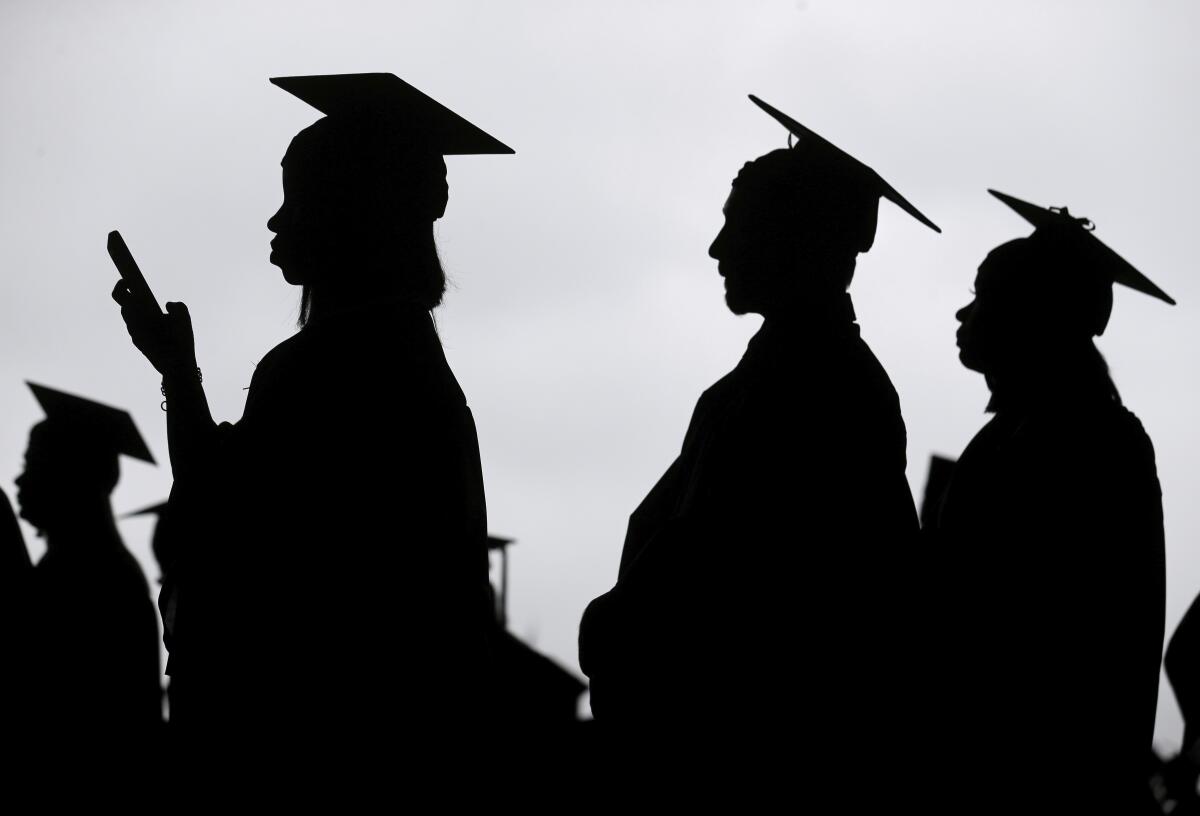 New graduates line up before the start of a community college commencement ceremony in East Rutherford, N.J., in 2018. 