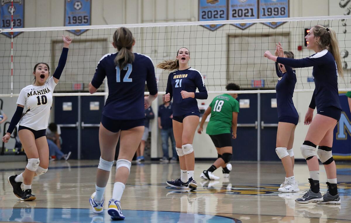 Teammates of Marina's Jalissa Costa (12) react to her fourth consecutive ace against Monrovia on Monday.