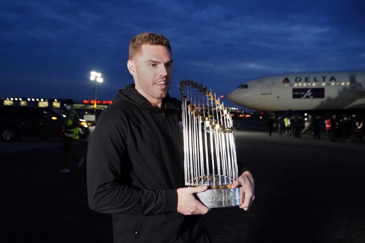 Atlanta first baseman Freddie Freeman holds the Commissioner's Trophy after the Braves' World Series win in November.