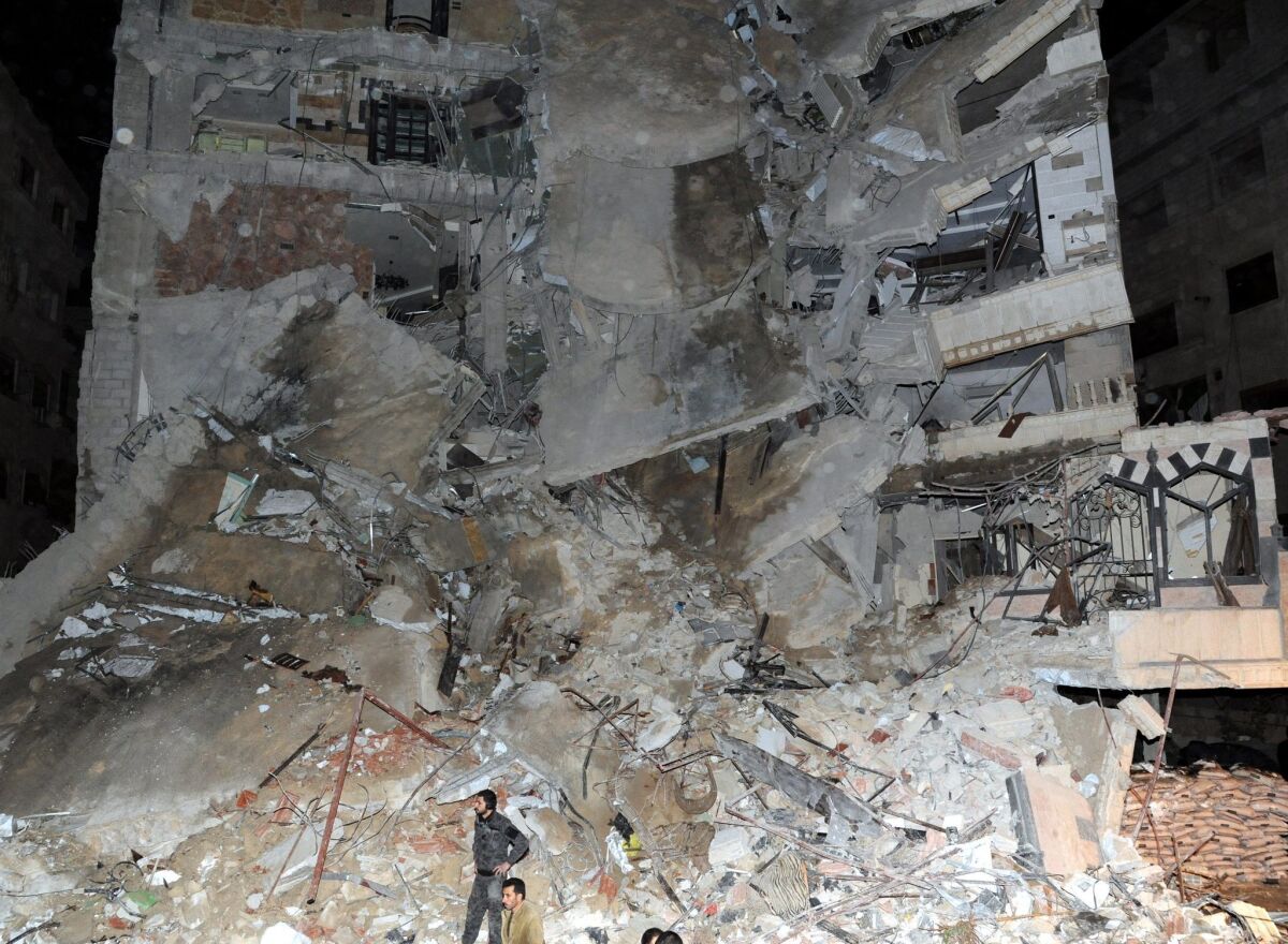 A handout photograph made available by the Syrian Arab news agency shows a residential building following an airstrike Sunday in Jaramana, Syria, that killed a Hezbollah operative.