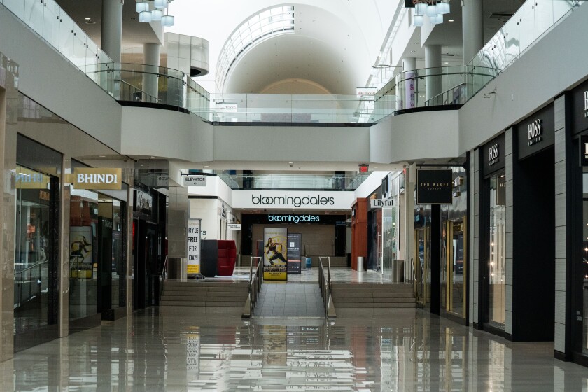 An empty corridor of the Glendale Galleria, where many shops, despite the mall’s reopening, remained closed on Thursday.