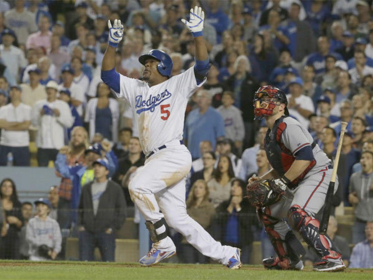 Juan Uribe hits a two-run home run in the eighth inning in Game 4 of the National League division series against Atlanta.