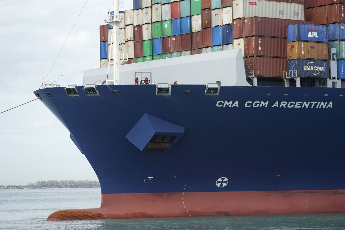 Crew members stand on the bow as the CMA CGM Argentina arrives at PortMiami