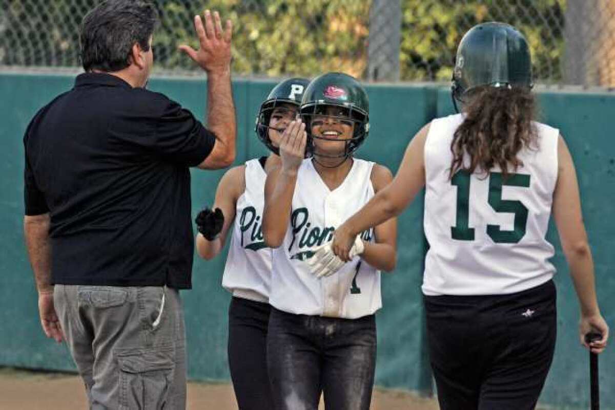 Providence's Tabitha Taylan and Ashley Corral get congratulations after scoring runs against Sherman on Monday, March 4, 2013.