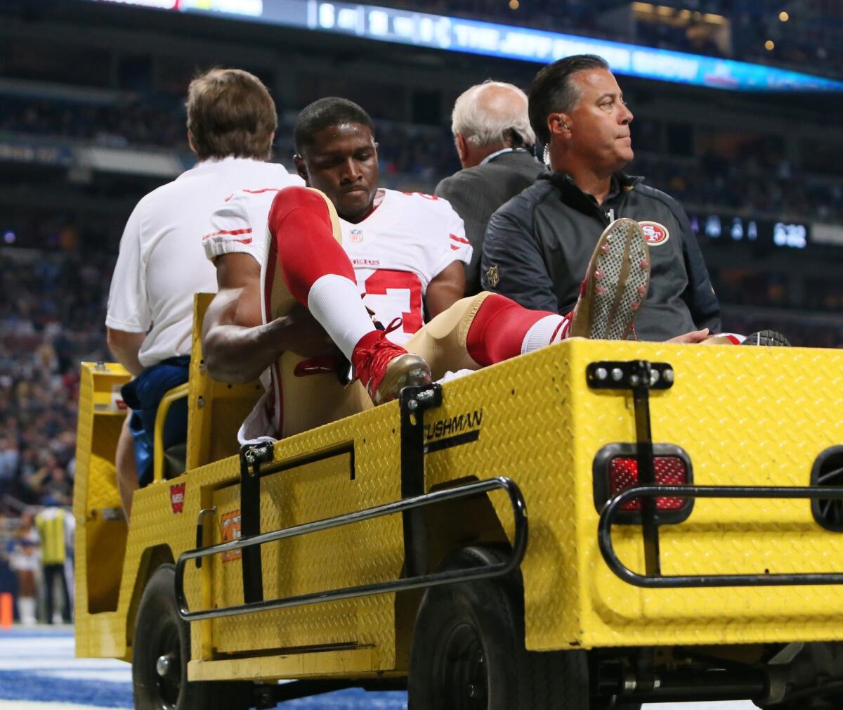 San Francisco running back Reggie Bush is carted off the field after being injured in St. Louis on Nov. 1.