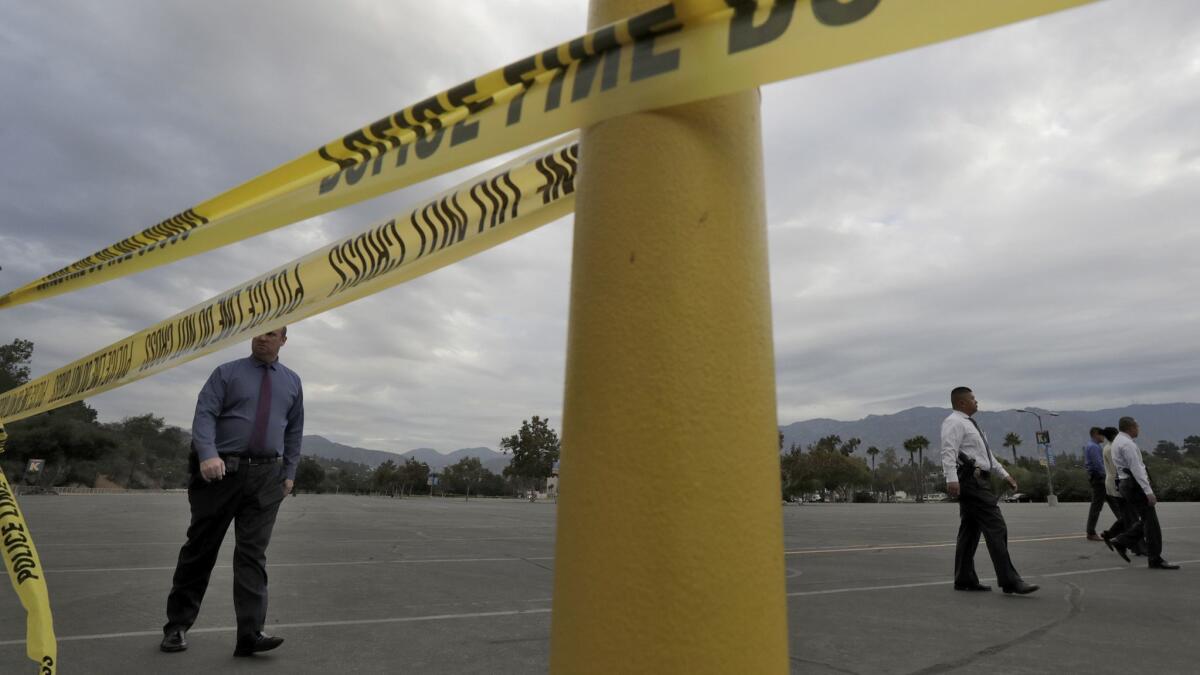 Pasadena police investigators scour parking Lot K at the Rose Bowl, where a man was stabbed to death Monday night.